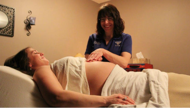 Woman receives prenatal massage therapy in Eau Claire and Chippewa Falls