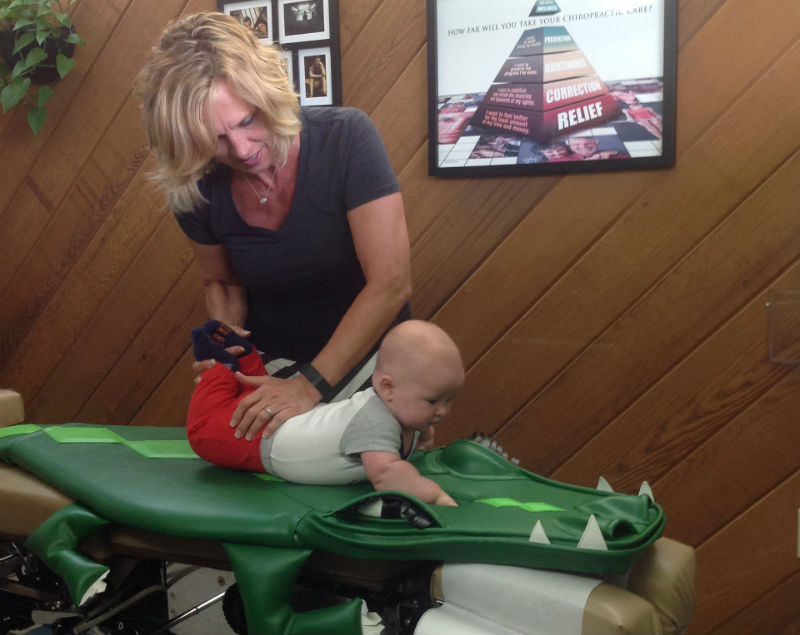 Chiropractor adjusting a baby